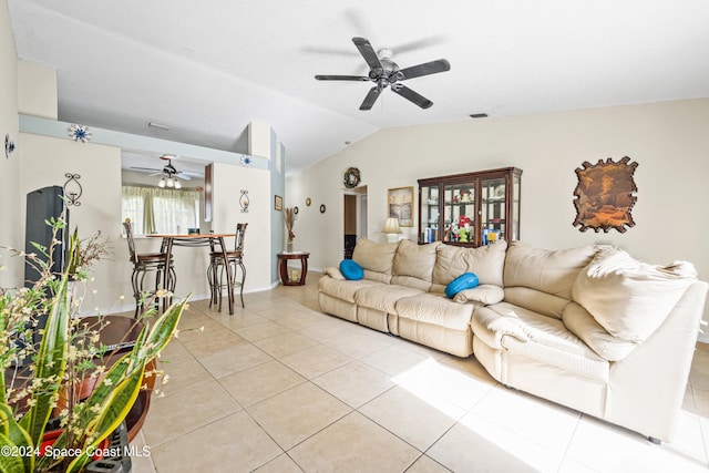 tiled living room with lofted ceiling and ceiling fan