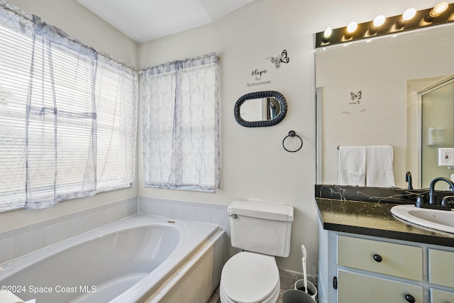 full bathroom featuring toilet, shower with separate bathtub, and vanity