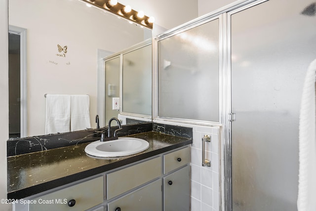 bathroom with vanity and an enclosed shower