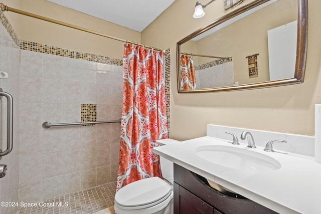 bathroom featuring toilet, vanity, and curtained shower