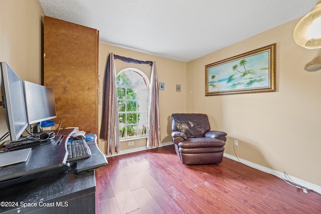 sitting room featuring hardwood / wood-style floors and a textured ceiling