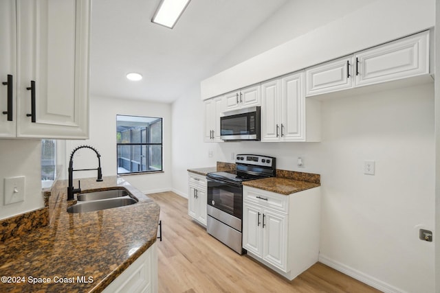 kitchen featuring white cabinets, appliances with stainless steel finishes, and sink