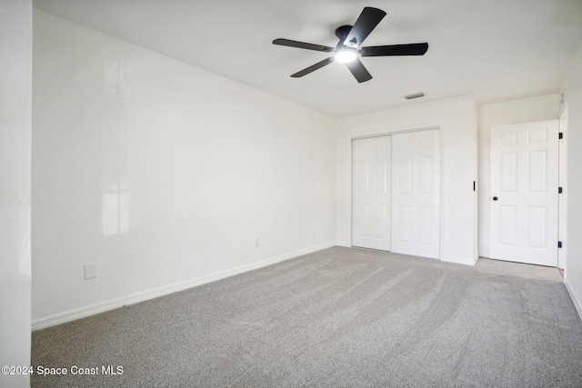 unfurnished bedroom with a closet, carpet, and ceiling fan