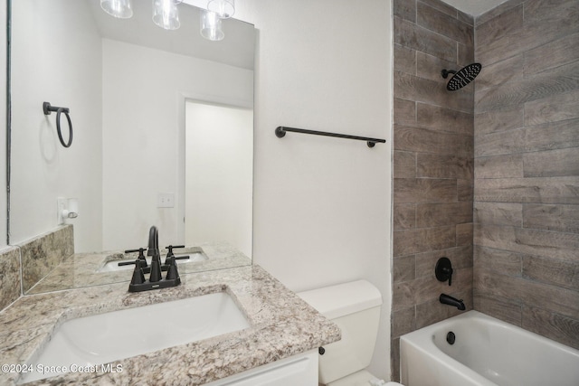 full bathroom featuring toilet, tiled shower / bath combo, and vanity