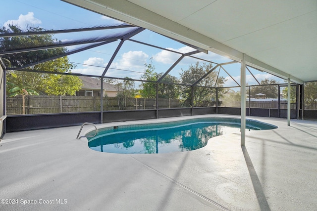 view of swimming pool featuring a lanai and a patio area