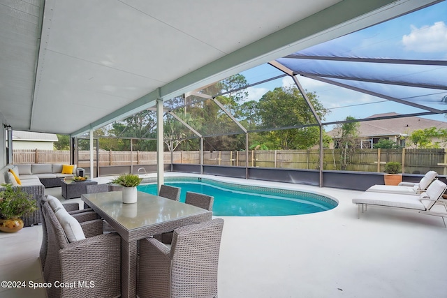 view of pool featuring a lanai, a patio, and an outdoor living space