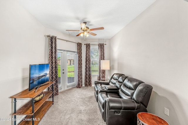 carpeted living room with ceiling fan and a textured ceiling