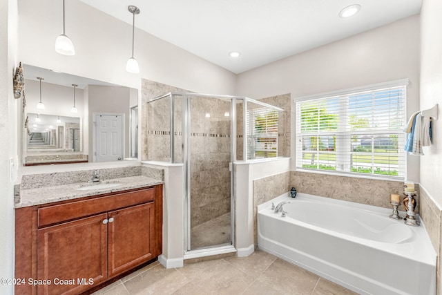 bathroom with vanity, tile patterned floors, and plus walk in shower