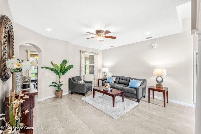 tiled living room featuring ceiling fan