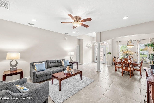 tiled living room featuring decorative columns and ceiling fan