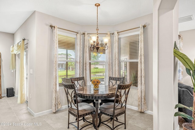 tiled dining area with a notable chandelier