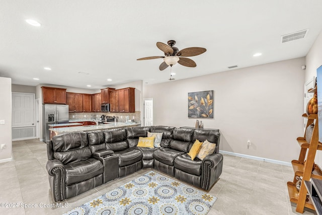 tiled living room with ceiling fan