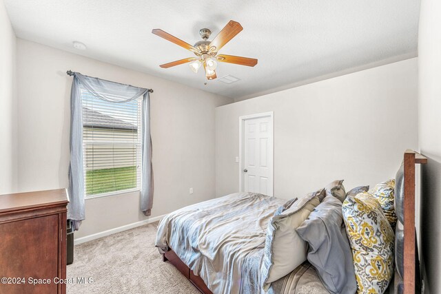 3540 Watergrass St, West Melbourne, FL 32904 - bedroom featuring light carpet, baseboards, and a ceiling fan