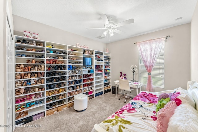 bedroom featuring a textured ceiling, ceiling fan, and carpet floors