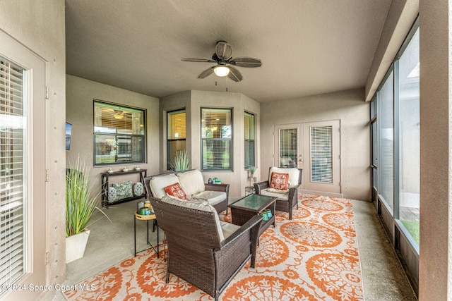 sunroom / solarium featuring a healthy amount of sunlight and ceiling fan