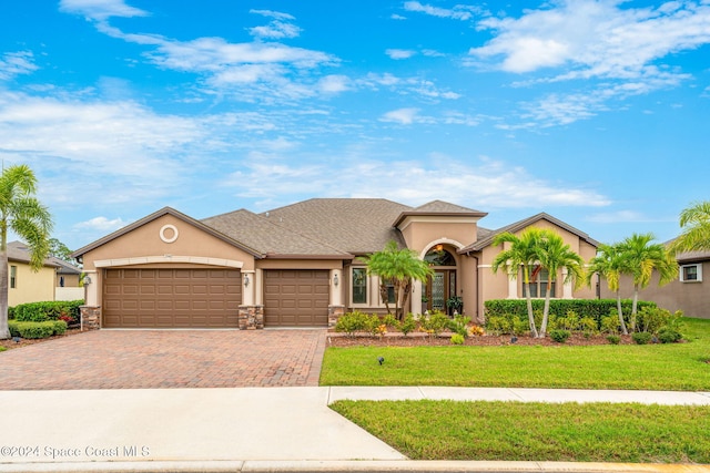 view of front of property featuring a garage and a front lawn