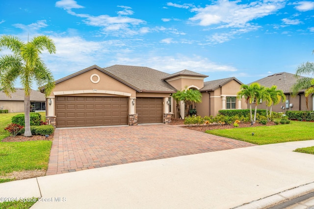 3540 Watergrass St, West Melbourne, FL 32904 - view of front of house with stucco siding, decorative driveway, an attached garage, and a front lawn
