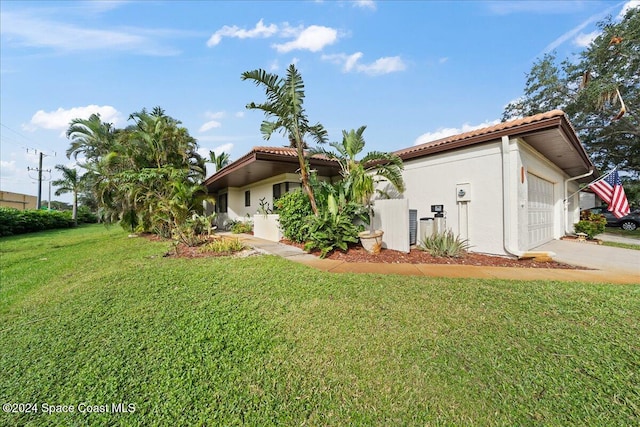 exterior space with a lawn and a garage