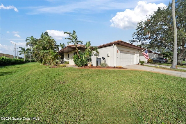 view of front of home with a garage and a front yard