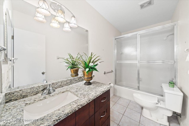 full bathroom featuring tile patterned floors, vanity, toilet, and shower / bath combination with glass door