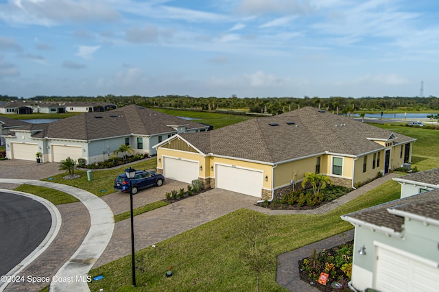 view of front of property with a garage and a front lawn