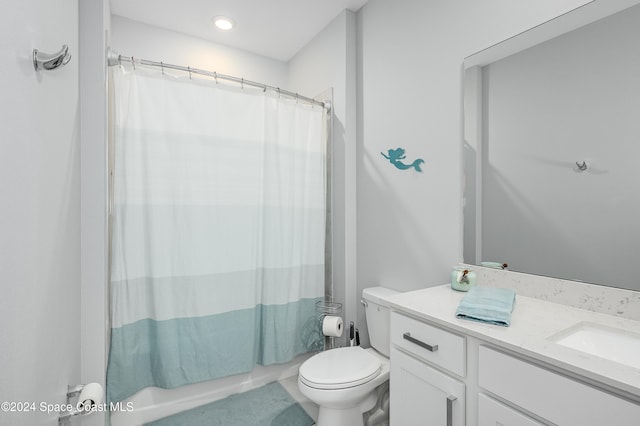 full bathroom with vanity, shower / bath combo with shower curtain, and toilet