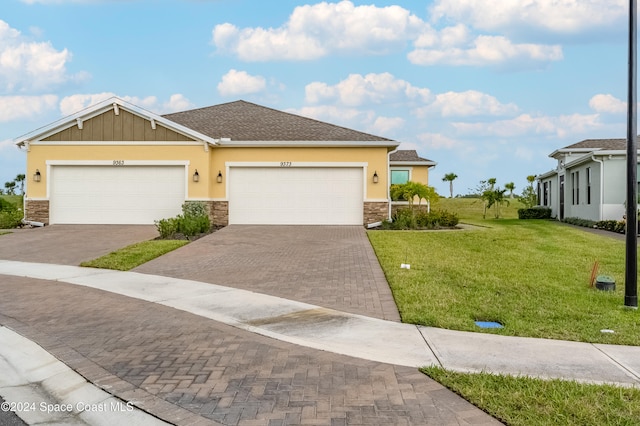 view of front of property with a garage and a front yard