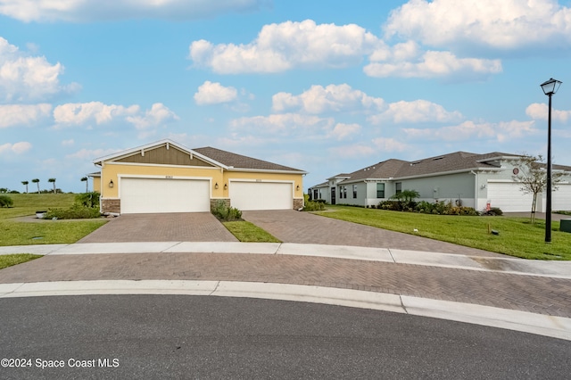 ranch-style home featuring a garage and a front yard