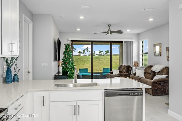 kitchen with stainless steel appliances, white cabinets, kitchen peninsula, sink, and ceiling fan