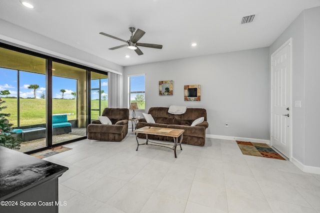 tiled living room with ceiling fan