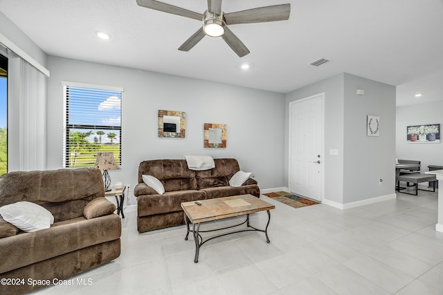 tiled living room featuring ceiling fan