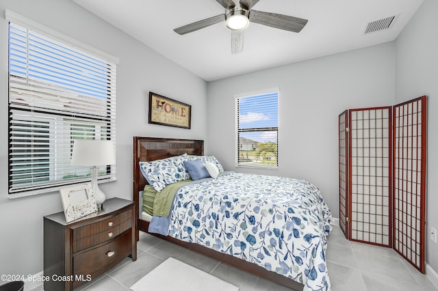 bedroom with ceiling fan and light tile patterned floors