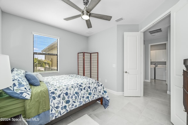 tiled bedroom with washing machine and clothes dryer and ceiling fan