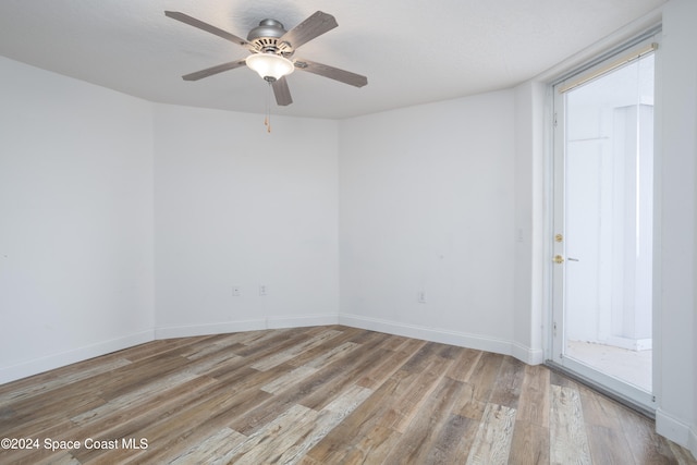 unfurnished room featuring light wood-type flooring and ceiling fan