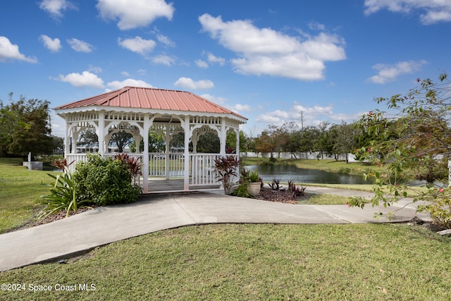 view of property's community featuring a water view, a yard, and a gazebo