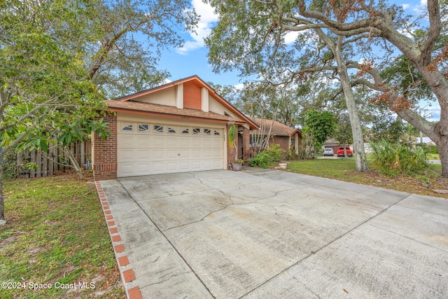 view of front of home featuring a garage and a front lawn