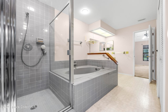 bathroom with ceiling fan and shower with separate bathtub