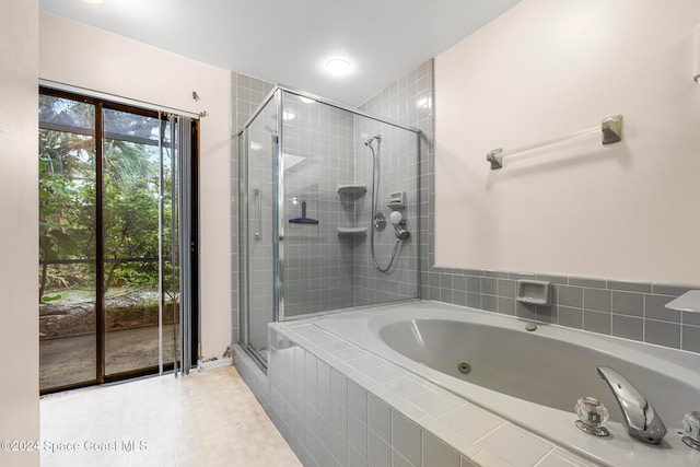 bathroom featuring shower with separate bathtub