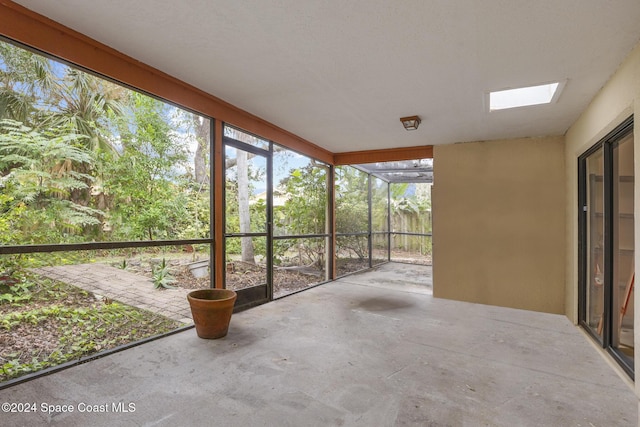 unfurnished sunroom with a skylight