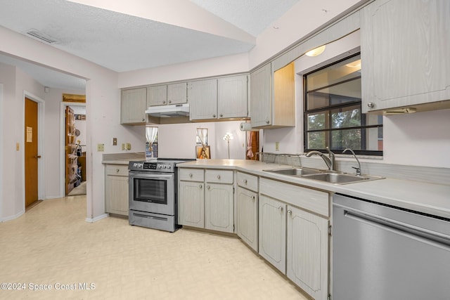 kitchen with lofted ceiling, sink, gray cabinets, a textured ceiling, and stainless steel appliances