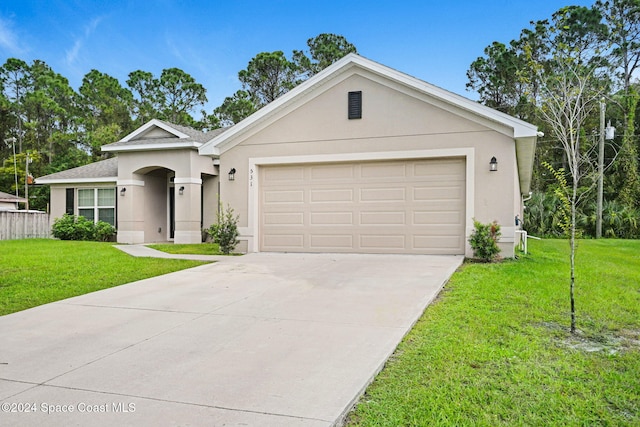 ranch-style house featuring a garage and a front yard