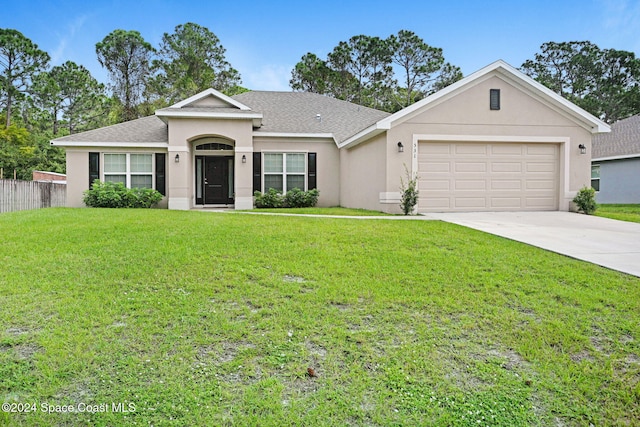 ranch-style home with a garage and a front yard