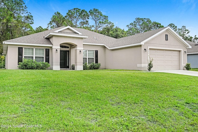 single story home with a garage and a front lawn