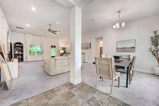 carpeted dining room with ceiling fan with notable chandelier