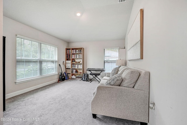 sitting room featuring carpet, plenty of natural light, and vaulted ceiling