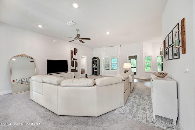 living room with ceiling fan and light carpet