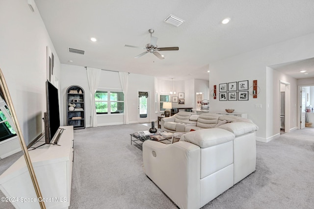 carpeted living room featuring ceiling fan