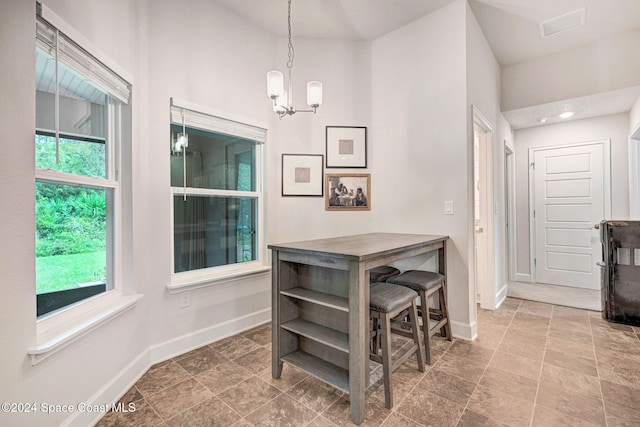 dining area featuring an inviting chandelier and plenty of natural light