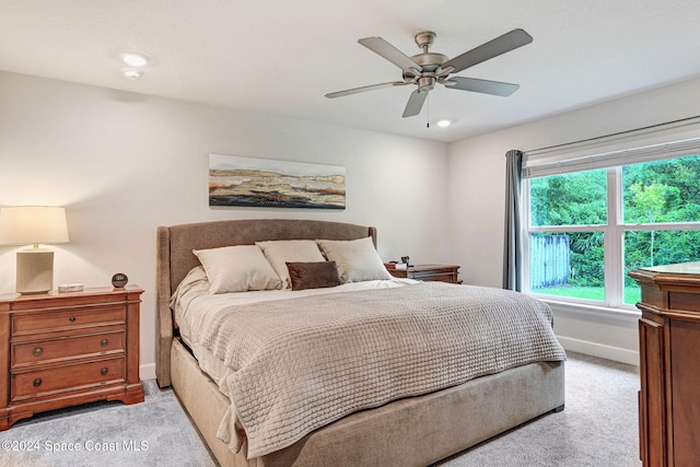 bedroom featuring light carpet and ceiling fan