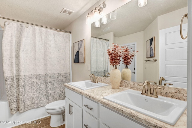 full bathroom featuring vanity, a textured ceiling, shower / tub combo, tile patterned flooring, and toilet